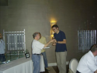 John Rosenstock give the prize to the winner, Pedro Cubillos